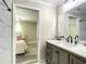 Open-concept view into the bathroom showcasing vanity with a large mirror and the marble-style tile shower at 634 Nw 56Th Ave, Ocala, FL 34482