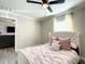 Light-filled bedroom features a comfortable bed with pink pillows, a ceiling fan, and plenty of space at 634 Nw 56Th Ave, Ocala, FL 34482