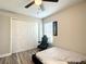 Cozy bedroom featuring a ceiling fan, closet, a window, and a sleek black gaming chair at 634 Nw 56Th Ave, Ocala, FL 34482