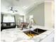Open-concept kitchen and living room boasts marble countertops, modern fixtures, and lots of natural light at 634 Nw 56Th Ave, Ocala, FL 34482