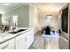 Bright kitchen flows into dining area featuring decorative chandelier, black dining table, and white countertops at 634 Nw 56Th Ave, Ocala, FL 34482