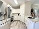 Bright kitchen featuring white cabinets, stainless steel appliances, and marble countertops at 634 Nw 56Th Ave, Ocala, FL 34482