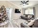 Comfortable living room featuring leather sofas, modern decor, and a festive Christmas tree at 634 Nw 56Th Ave, Ocala, FL 34482