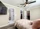 Cozy main bedroom with a ceiling fan, a walk-in closet, and an attached, tiled bathroom with a modern shower at 634 Nw 56Th Ave, Ocala, FL 34482