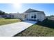 Charming single-story home with a well-manicured lawn and a long concrete driveway leading to the entrance at 6584 Se 108Th Ln, Belleview, FL 34420