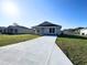 Inviting single-story home featuring a well-kept lawn and a spacious concrete driveway at 6584 Se 108Th Ln, Belleview, FL 34420