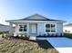 Lovely single-story home featuring a covered porch, a well-kept lawn and simple front yard landscaping at 6584 Se 108Th Ln, Belleview, FL 34420