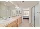 Bright bathroom features double sinks, a large mirror, neutral counters, and a glass-enclosed shower stall at 7092 Sw 93Rd Ave # 1, Ocala, FL 34481
