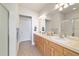 Bathroom features a large mirror above the vanity with double sinks, a tiled floor, and a glass enclosed shower stall at 7092 Sw 93Rd Ave # 1, Ocala, FL 34481