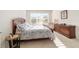 Sun-drenched bedroom features a large window, a wooden bed frame, and a matching dresser at 7092 Sw 93Rd Ave # 1, Ocala, FL 34481