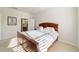 Well-lit bedroom with neutral walls and carpet, features a wooden bed frame and easy access to the Primary bathroom at 7092 Sw 93Rd Ave # 1, Ocala, FL 34481