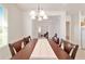 Bright dining room featuring a wood table and a decorative chandelier at 7092 Sw 93Rd Ave # 1, Ocala, FL 34481