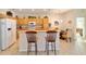 Eat-in kitchen with breakfast bar, white appliances, and tile floors at 7092 Sw 93Rd Ave # 1, Ocala, FL 34481
