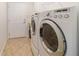 Functional laundry room with tile flooring, washer, dryer, and storage at 7092 Sw 93Rd Ave # 1, Ocala, FL 34481