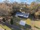 Aerial shot of the house, fenced yard, and detached storage shed at 7280 Se County Highway 25A, Belleview, FL 34420