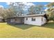 Back of the house with a screened in patio and large backyard at 7280 Se County Highway 25A, Belleview, FL 34420