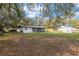 Expansive backyard with well-maintained lawn and detached shed, perfect for outdoor activities at 7280 Se County Highway 25A, Belleview, FL 34420