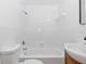 Bright bathroom showcasing a bathtub with shower, toilet and sink with vanity at 7280 Se County Highway 25A, Belleview, FL 34420