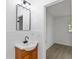 Bathroom featuring a vanity, mirror and shower; includes access to separate room at 7280 Se County Highway 25A, Belleview, FL 34420