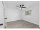 Bedroom with a new ceiling fan, white walls, a window and modern light gray flooring at 7280 Se County Highway 25A, Belleview, FL 34420
