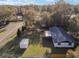 Backyard view of single-story home, storage shed, and spacious grassy area at 7280 Se County Highway 25A, Belleview, FL 34420