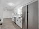 Bright and airy kitchen with stainless steel refrigerator and a view to the living room at 7280 Se County Highway 25A, Belleview, FL 34420