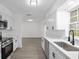 Updated kitchen with stainless appliances, new cabinets, countertops, and view to a living area at 7280 Se County Highway 25A, Belleview, FL 34420