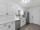 Bright kitchen features stainless steel appliances, white cabinets, and modern black hardware at 7280 Se County Highway 25A, Belleview, FL 34420