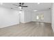 Spacious living room features recessed lighting, gray wood-look flooring, and french doors at 7280 Se County Highway 25A, Belleview, FL 34420