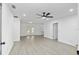 Bright living room featuring sleek, light wood-look flooring and a modern ceiling fan at 7280 Se County Highway 25A, Belleview, FL 34420