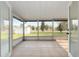 Enclosed patio with tile flooring; great view of the backyard at 7280 Se County Highway 25A, Belleview, FL 34420
