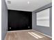 Sizable bedroom with a black accent wall and natural light, offering a versatile living space at 8371 Sw 59Th Ter, Ocala, FL 34476