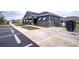 Community clubhouse featuring ample parking, convenient mailboxes, and a welcoming exterior design at 8371 Sw 59Th Ter, Ocala, FL 34476