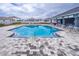 Beautiful community pool with paved surroundings and a covered lounge area for residents at 8371 Sw 59Th Ter, Ocala, FL 34476