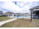 Relaxing community pool surrounded by a secure black metal fence and bright blue skies at 8371 Sw 59Th Ter, Ocala, FL 34476