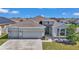 A beautifully landscaped home with a three-car garage, showcasing its appealing exterior elevation at 8371 Sw 59Th Ter, Ocala, FL 34476