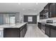 Modern kitchen with stainless steel appliances, gray countertops, and dark wood cabinetry at 8371 Sw 59Th Ter, Ocala, FL 34476