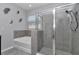 Main bathroom showing the garden tub, glass shower, neutral gray tile, and a window for natural light at 8371 Sw 59Th Ter, Ocala, FL 34476