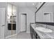 Main bathroom with double granite countertop vanity, ample storage, and lots of natural light at 8371 Sw 59Th Ter, Ocala, FL 34476
