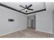 Main bedroom featuring carpet floors, a tray ceiling, and a wall-mounted bracket for a TV at 8371 Sw 59Th Ter, Ocala, FL 34476