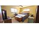 Cozy bedroom with soft lighting, comfortable furnishings, and dual windows at 8516 Sw 105Th Pl, Ocala, FL 34481
