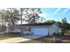 Charming single-story home with a well-maintained lawn and a two-car garage and mature landscaping at 8516 Sw 105Th Pl, Ocala, FL 34481