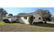 Rear exterior view of home, showing the enclosed porch, lush landscaping, and well-maintained yard at 8516 Sw 105Th Pl, Ocala, FL 34481