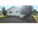 Side view of a cozy house with well-maintained lawn and window views at 8516 Sw 105Th Pl, Ocala, FL 34481