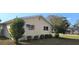 Side view of a cozy house with well-maintained lawn and window views at 8516 Sw 105Th Pl, Ocala, FL 34481