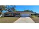 Charming single-story home with a well-maintained lawn and a two-car garage at 8516 Sw 105Th Pl, Ocala, FL 34481