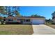 Charming single-story home with a well-maintained lawn and a two-car garage at 8516 Sw 105Th Pl, Ocala, FL 34481