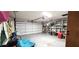 Spacious garage with ample storage, a large door, and functional lighting at 8516 Sw 105Th Pl, Ocala, FL 34481