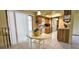 Bright kitchen with tile floors, wood cabinets, and adjacent dining area with white table at 8516 Sw 105Th Pl, Ocala, FL 34481