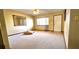 Inviting living room with neutral carpet, ceiling fan, and a mirror adding depth at 8516 Sw 105Th Pl, Ocala, FL 34481
